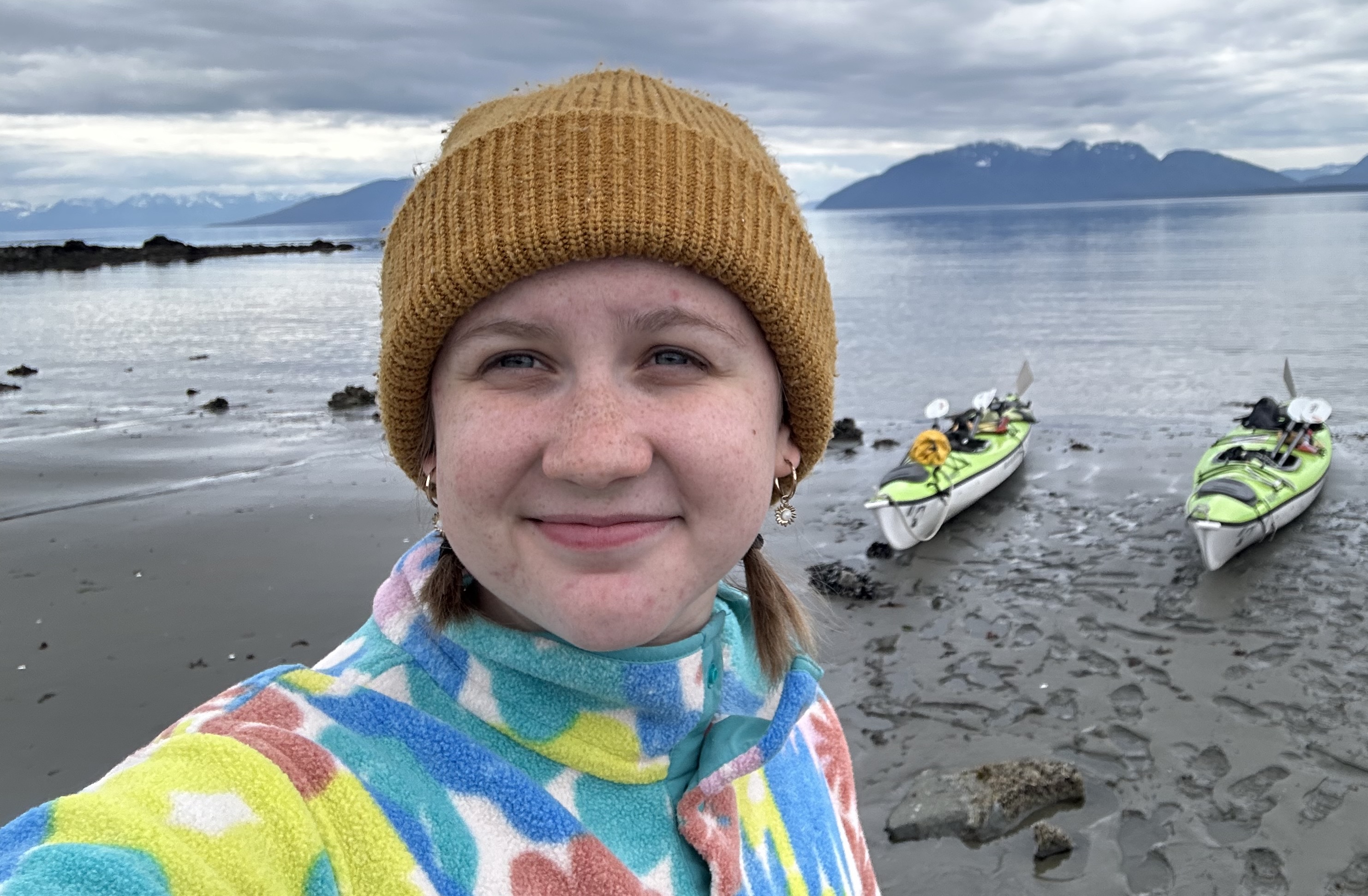 A student with kayaks in the background.